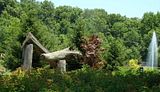 DSC04577af.jpg A large log sculpture, and a fountain in a nearby pond. image by Shut-R-Bug