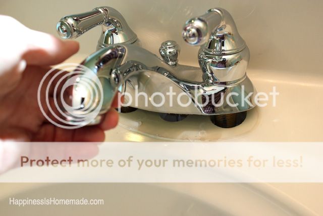 old sink faucet being removed from bathroom sink