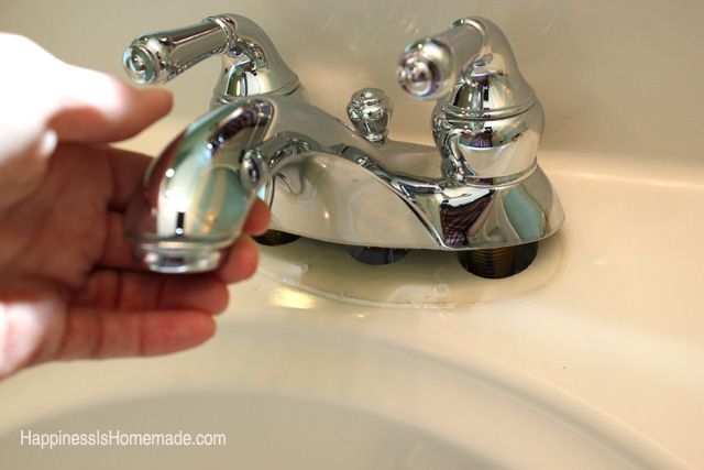 old sink faucet being removed from bathroom sink